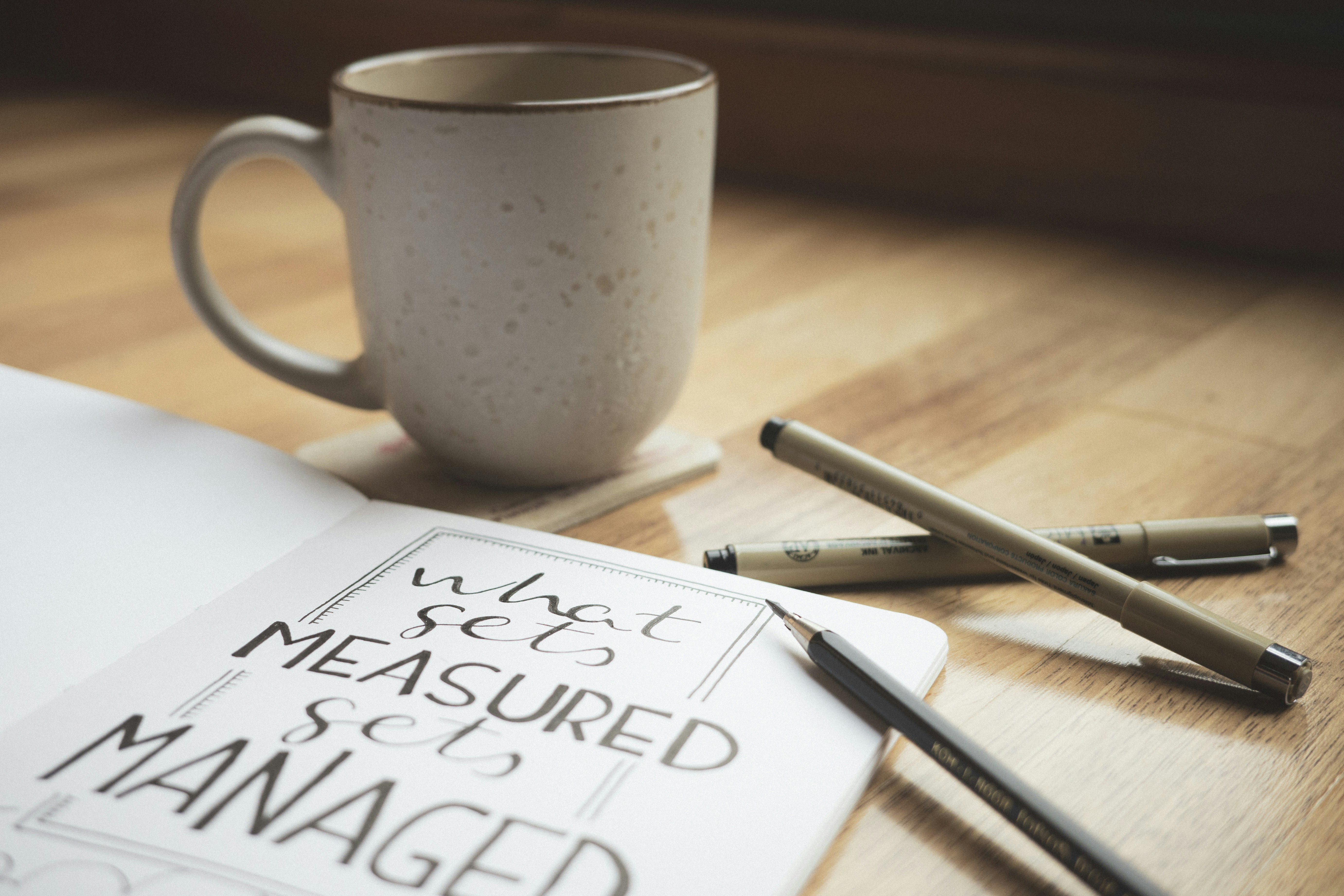 A cup of coffee sitting on top of a wooden table