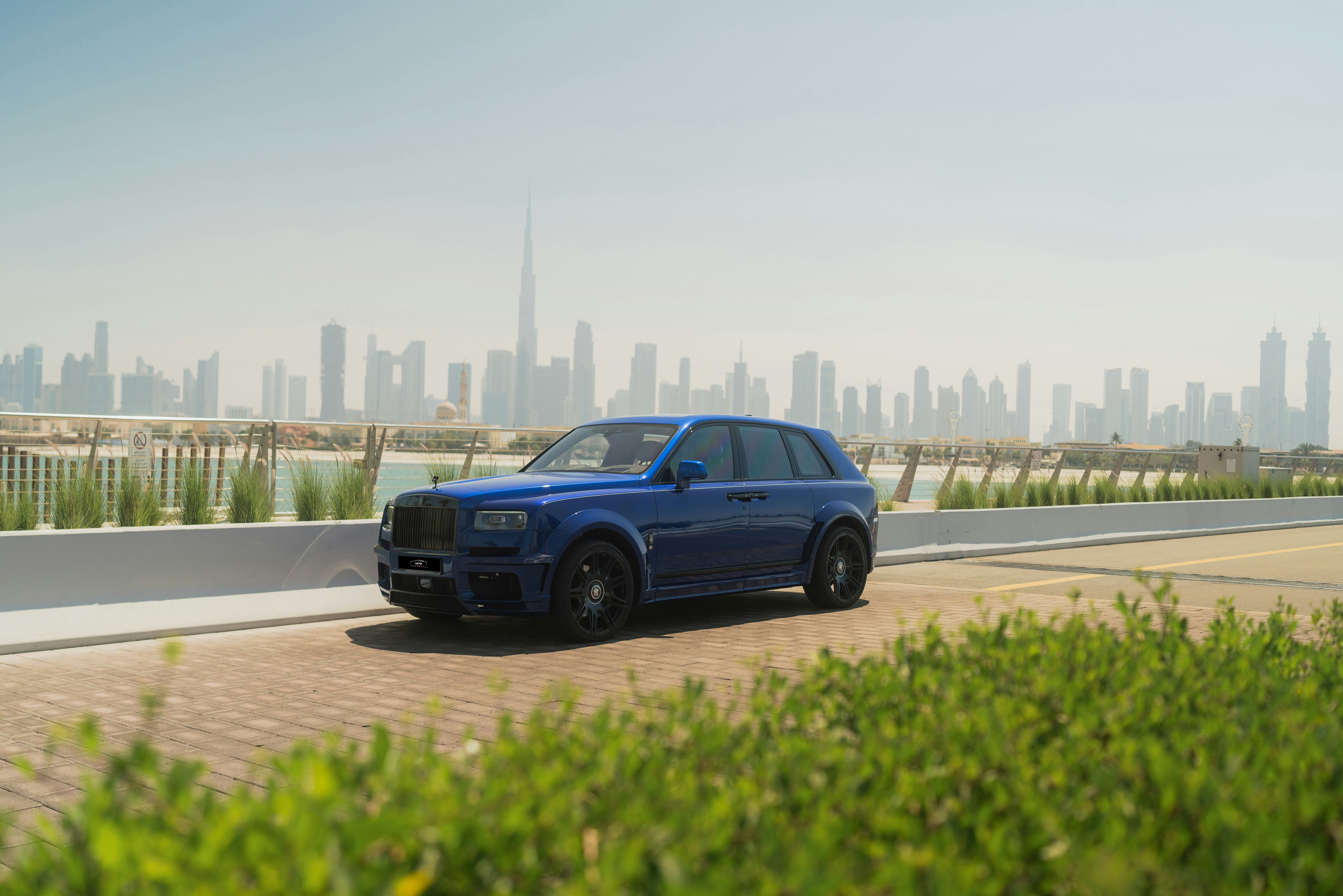 Un suv blu che percorre una strada di fronte a una città