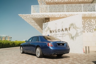 A blue car parked in front of a building