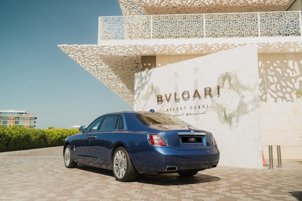A blue car parked in front of a building