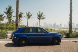 A blue car parked on the side of the road