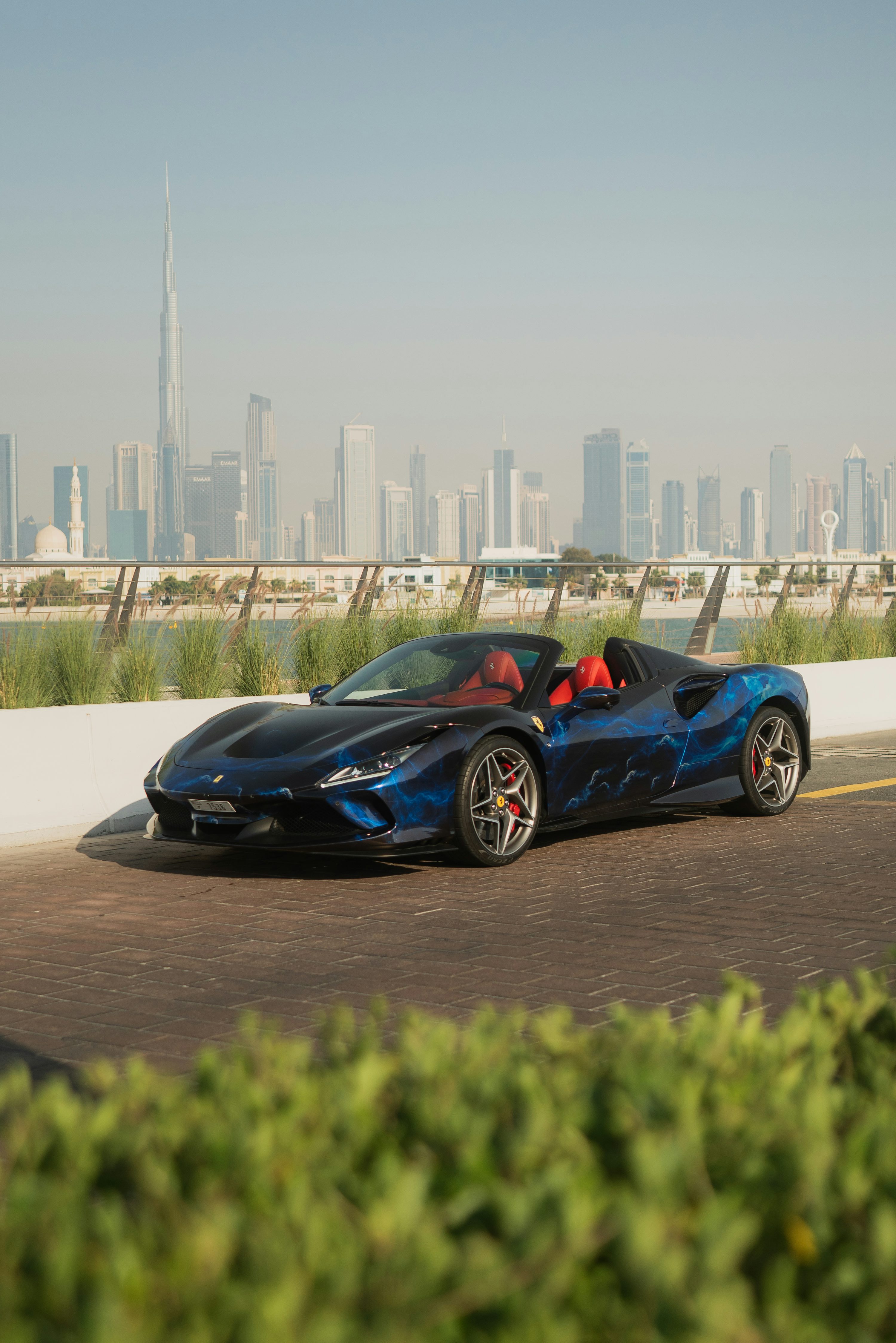 A blue sports car driving down the road