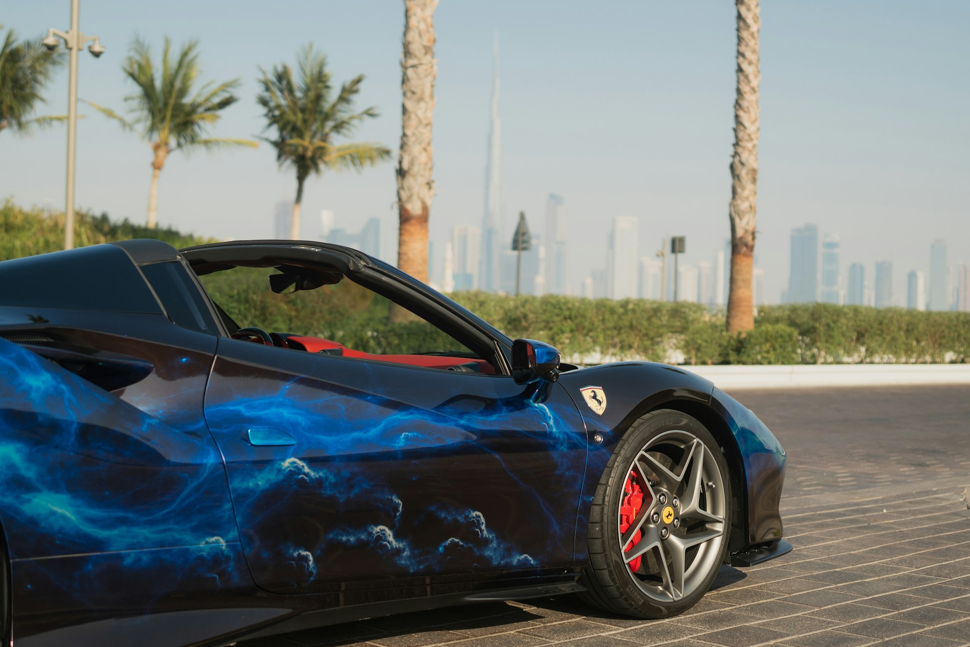 A blue sports car parked on the side of the road