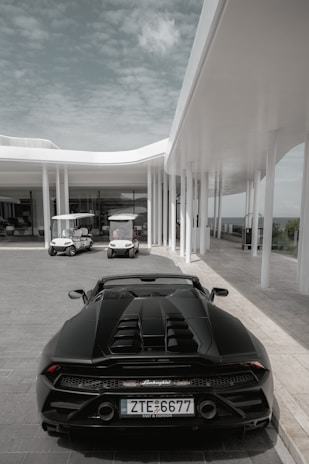 A black sports car parked in front of a building