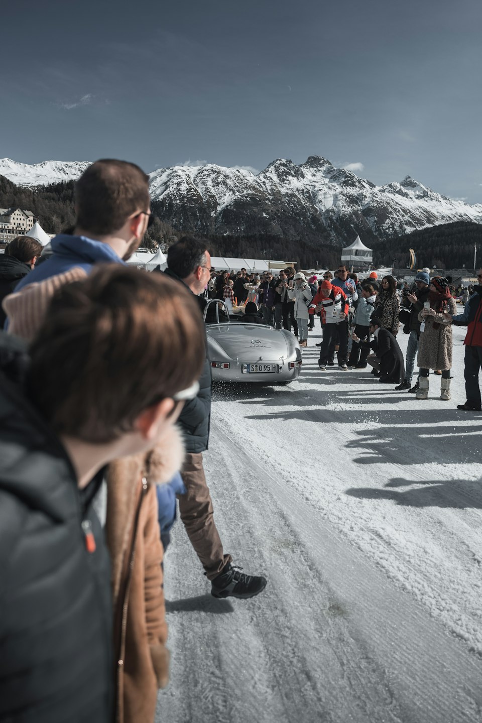 People walking along a snow-covered street in St. Moritz, Switzerland