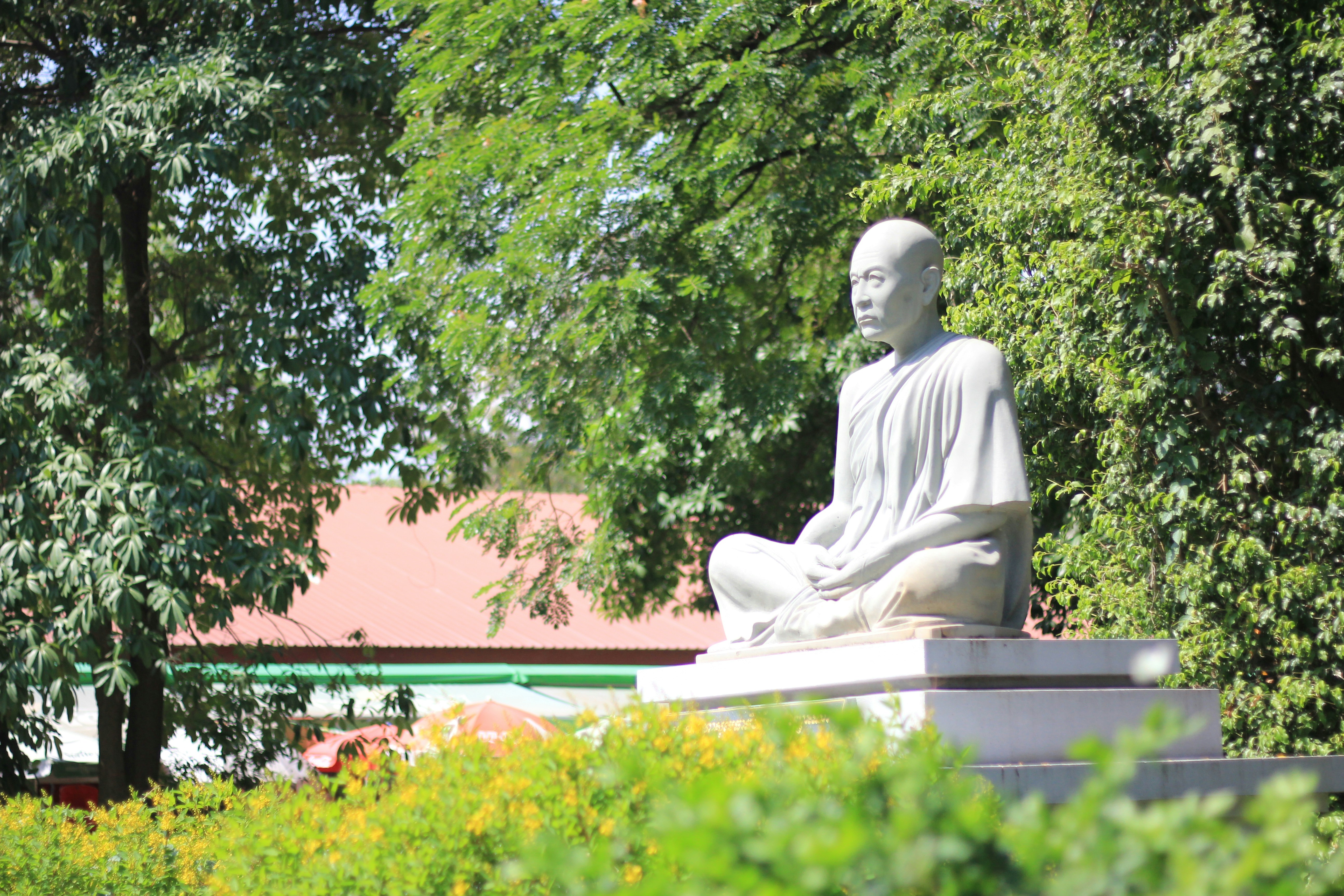 A statue of a person sitting in a meditation position