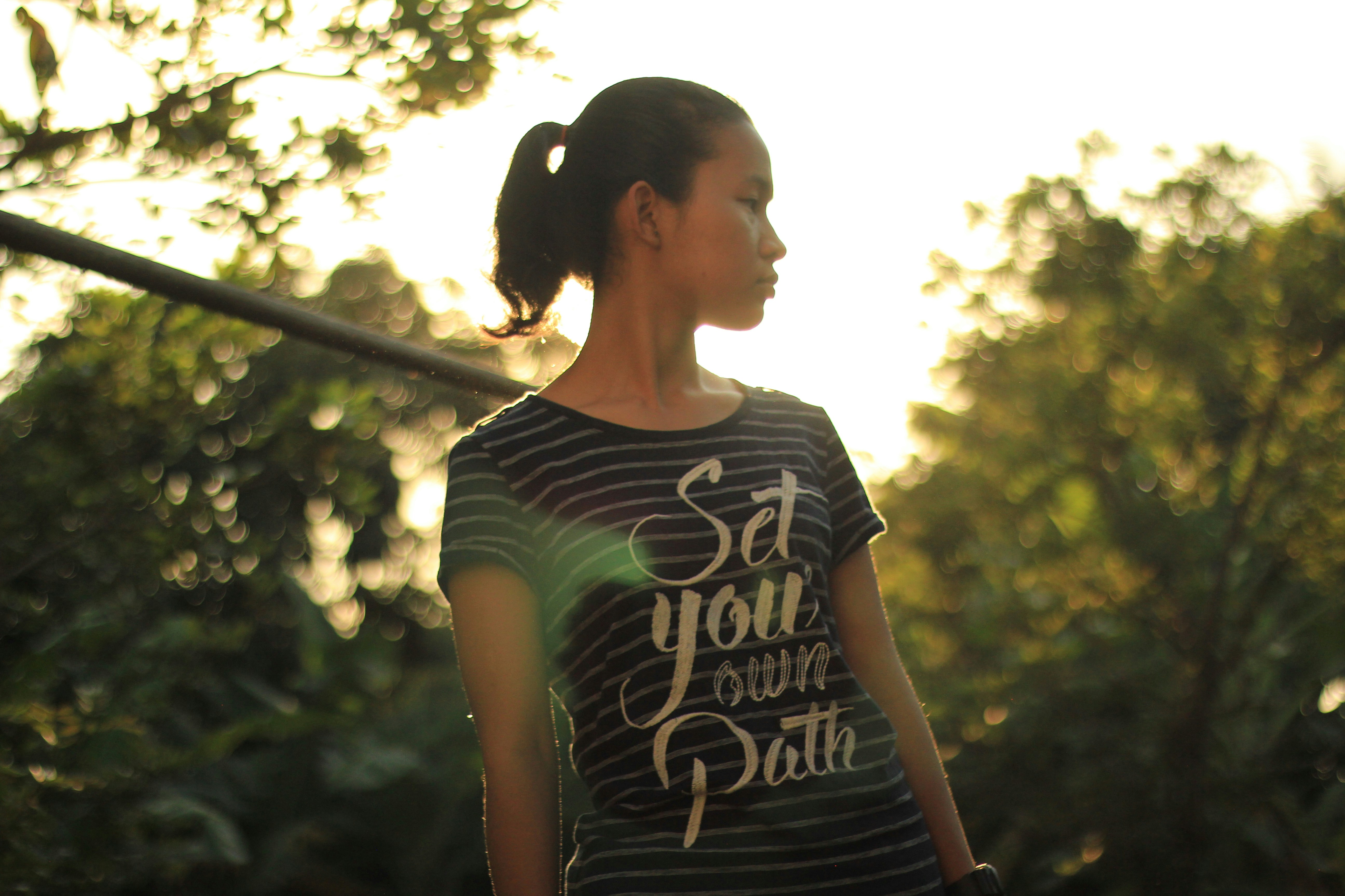 A woman standing in front of a baseball bat