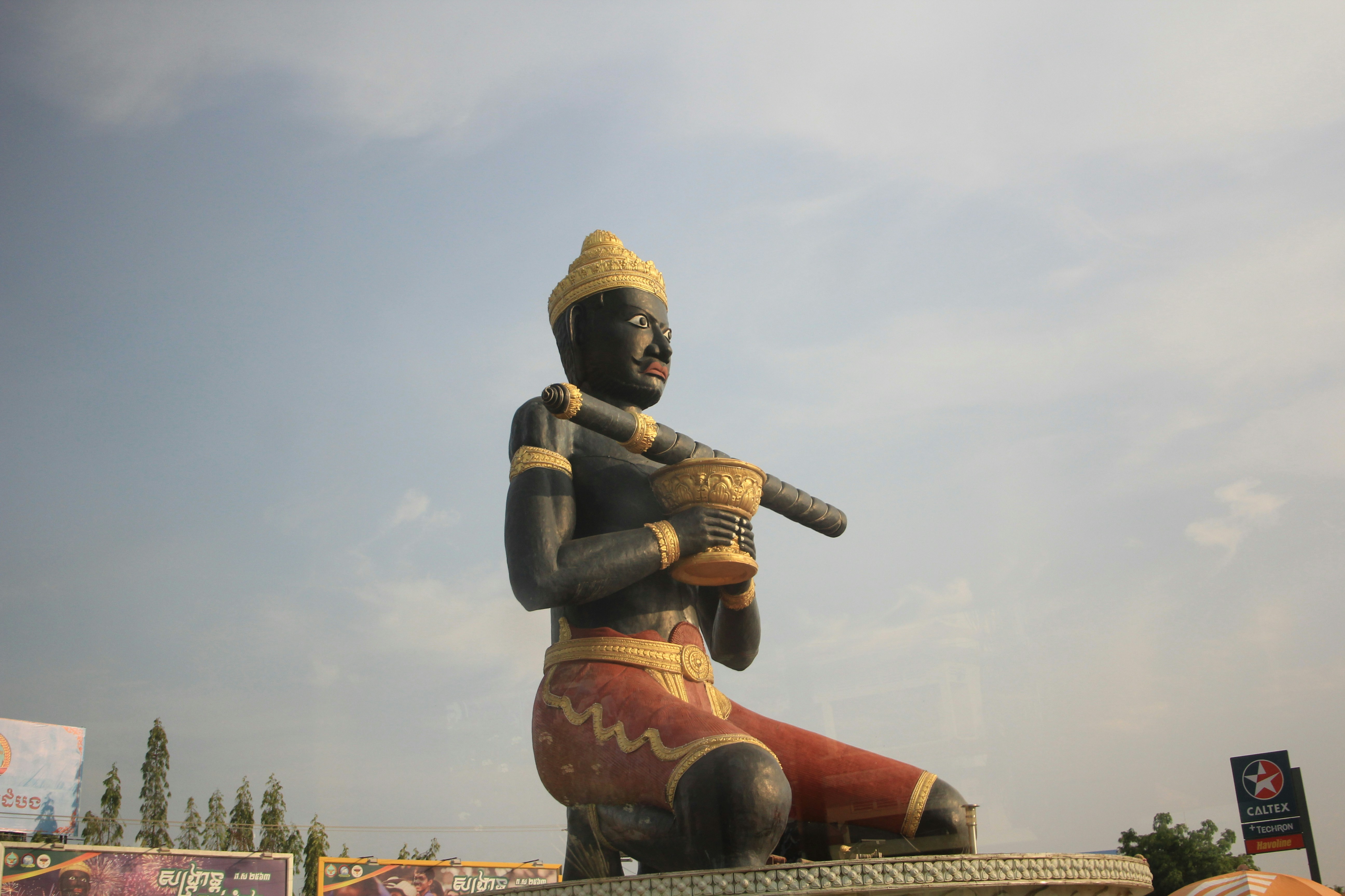 A statue of a man holding a baseball bat