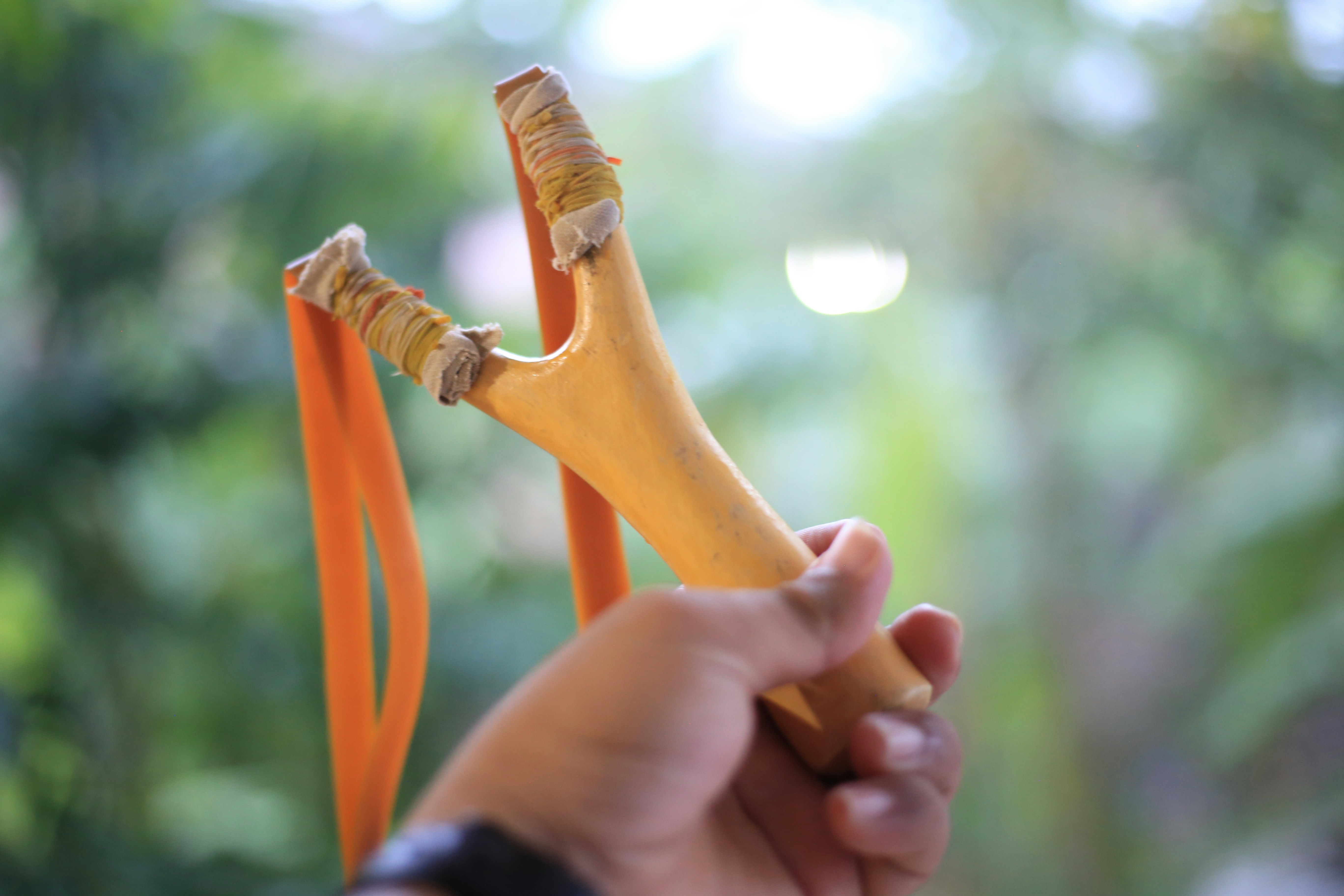 Picture of a hand holding a slingshot.