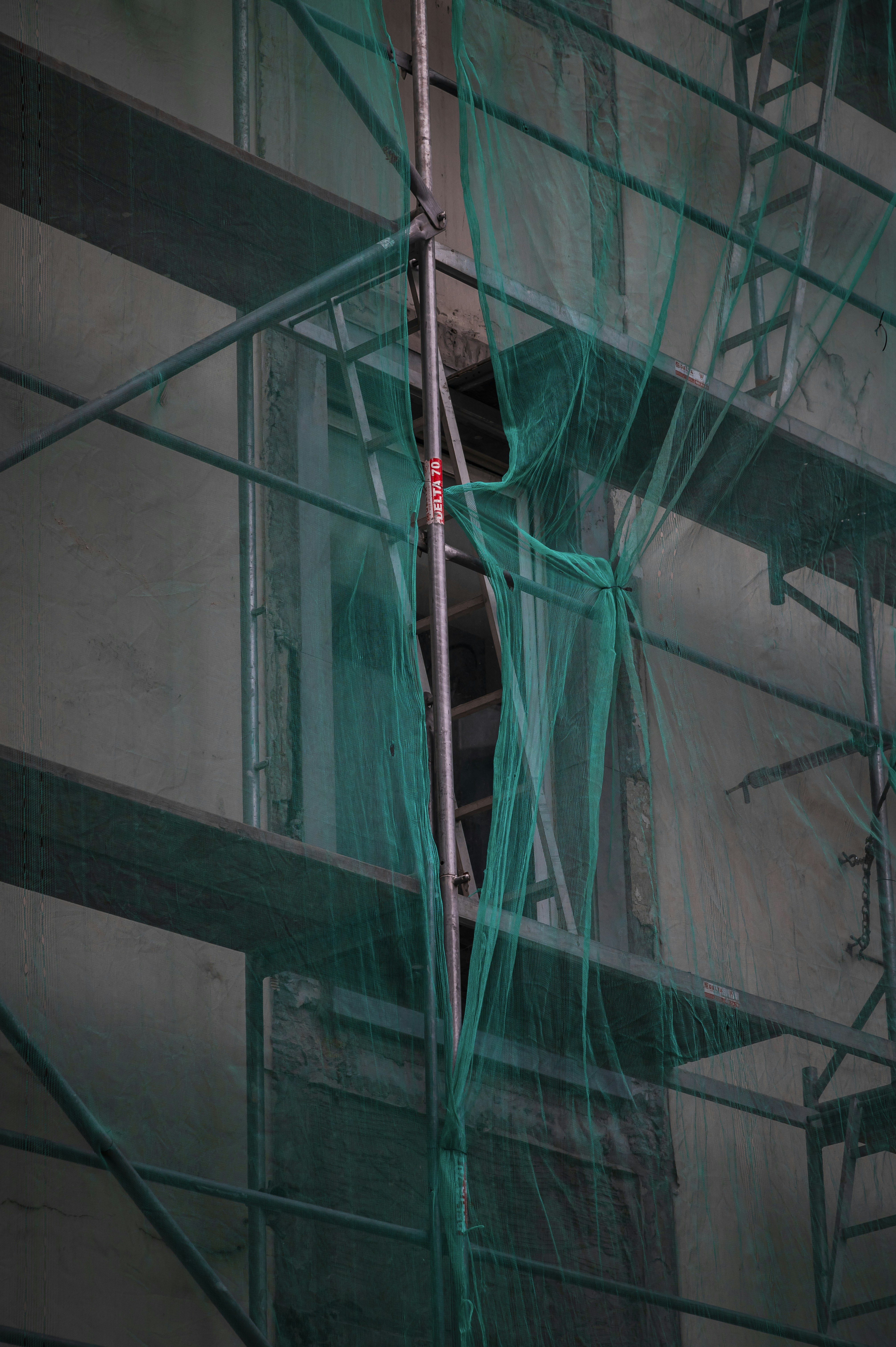 Scaffolding around a building with a clock on it