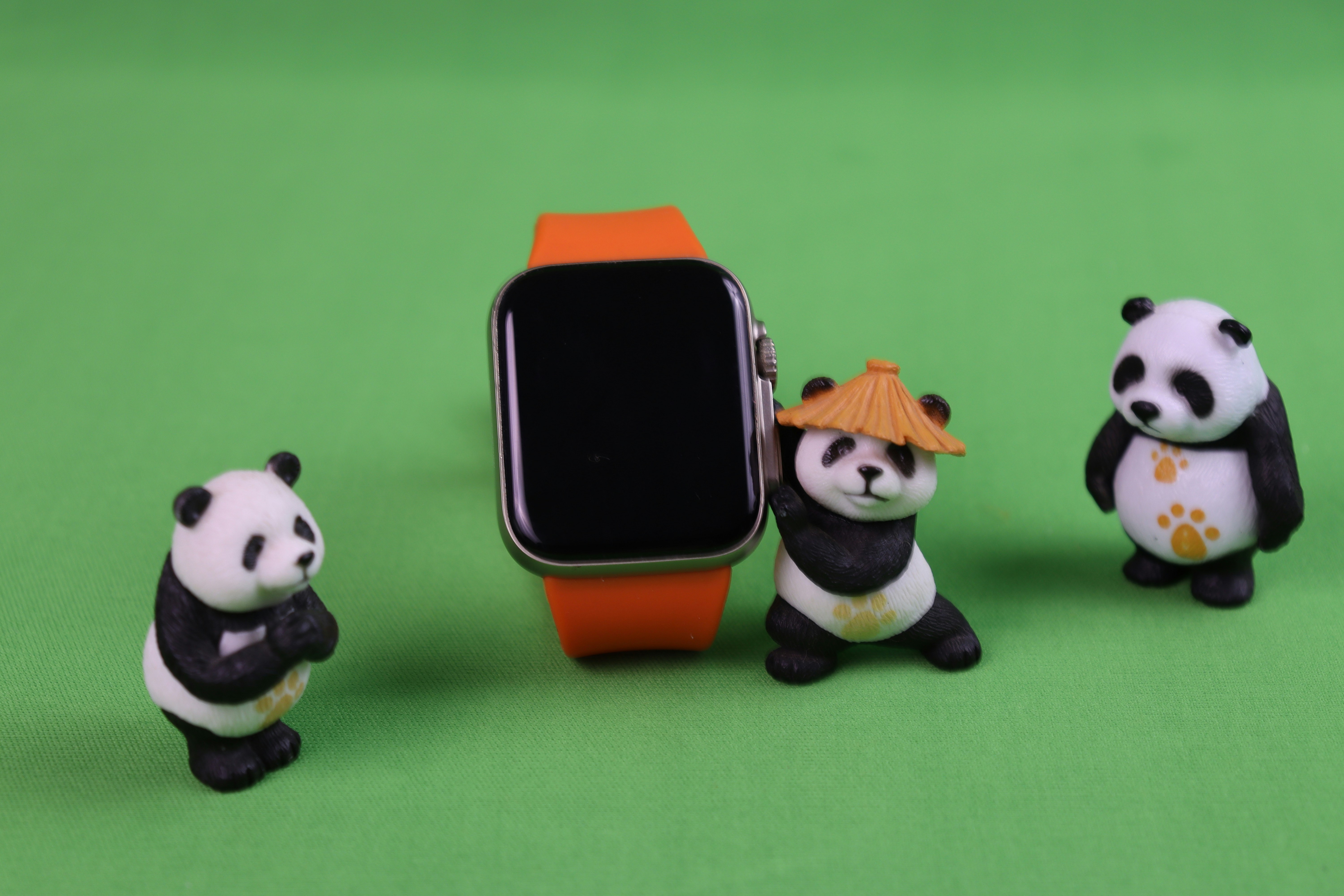 A group of panda bears standing next to each other