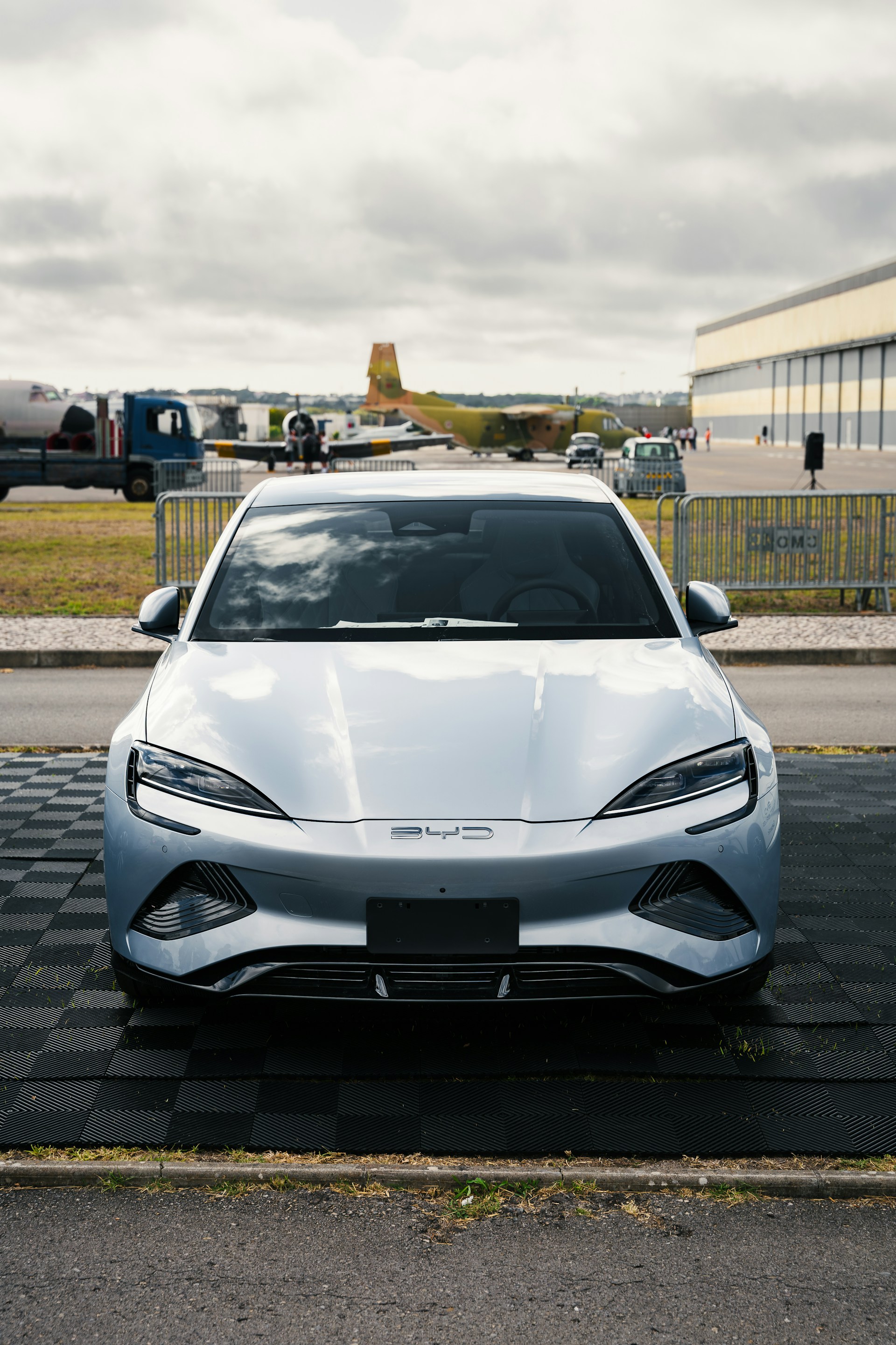 A silver sports car parked in a parking lot