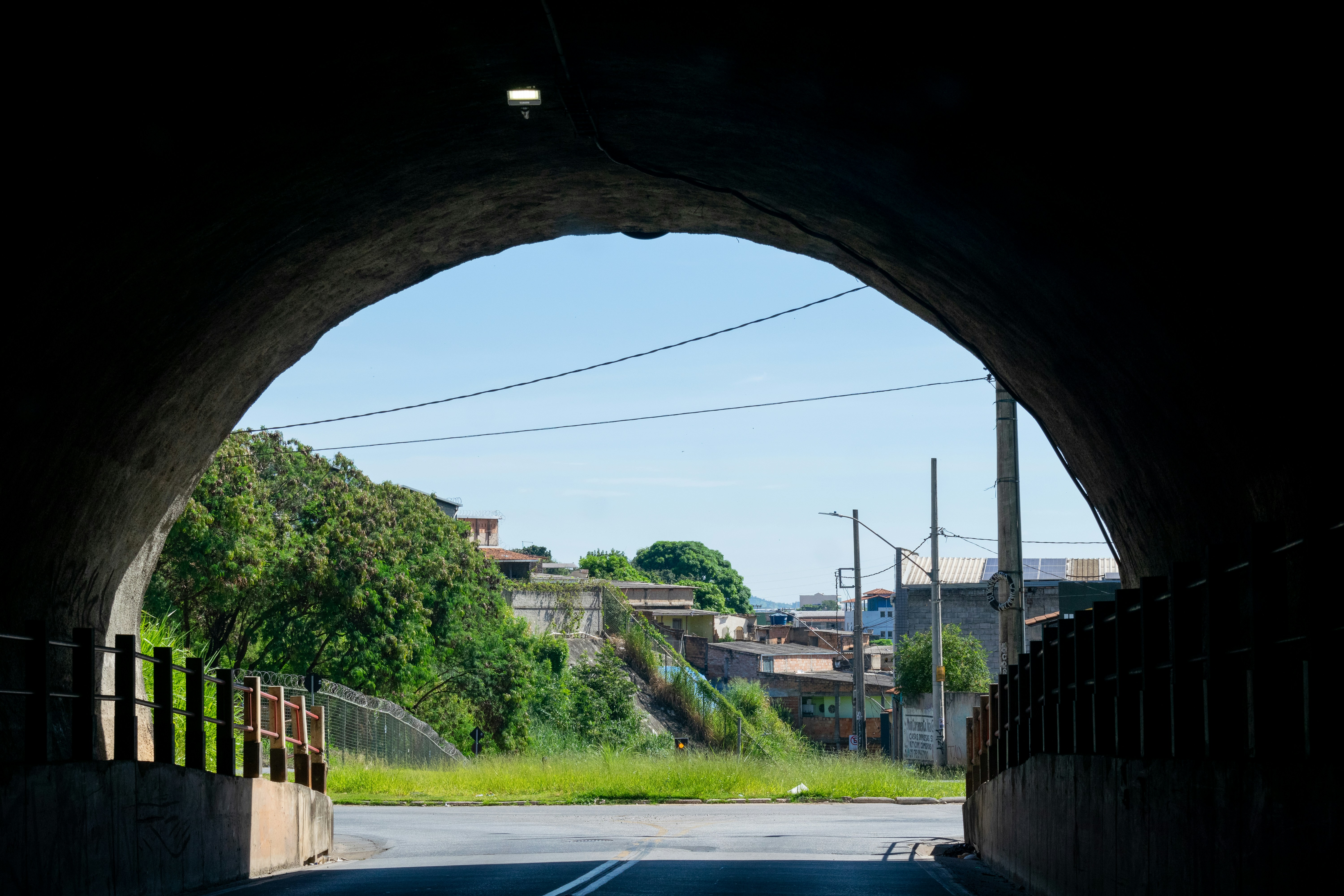A dark tunnel with a road going through it