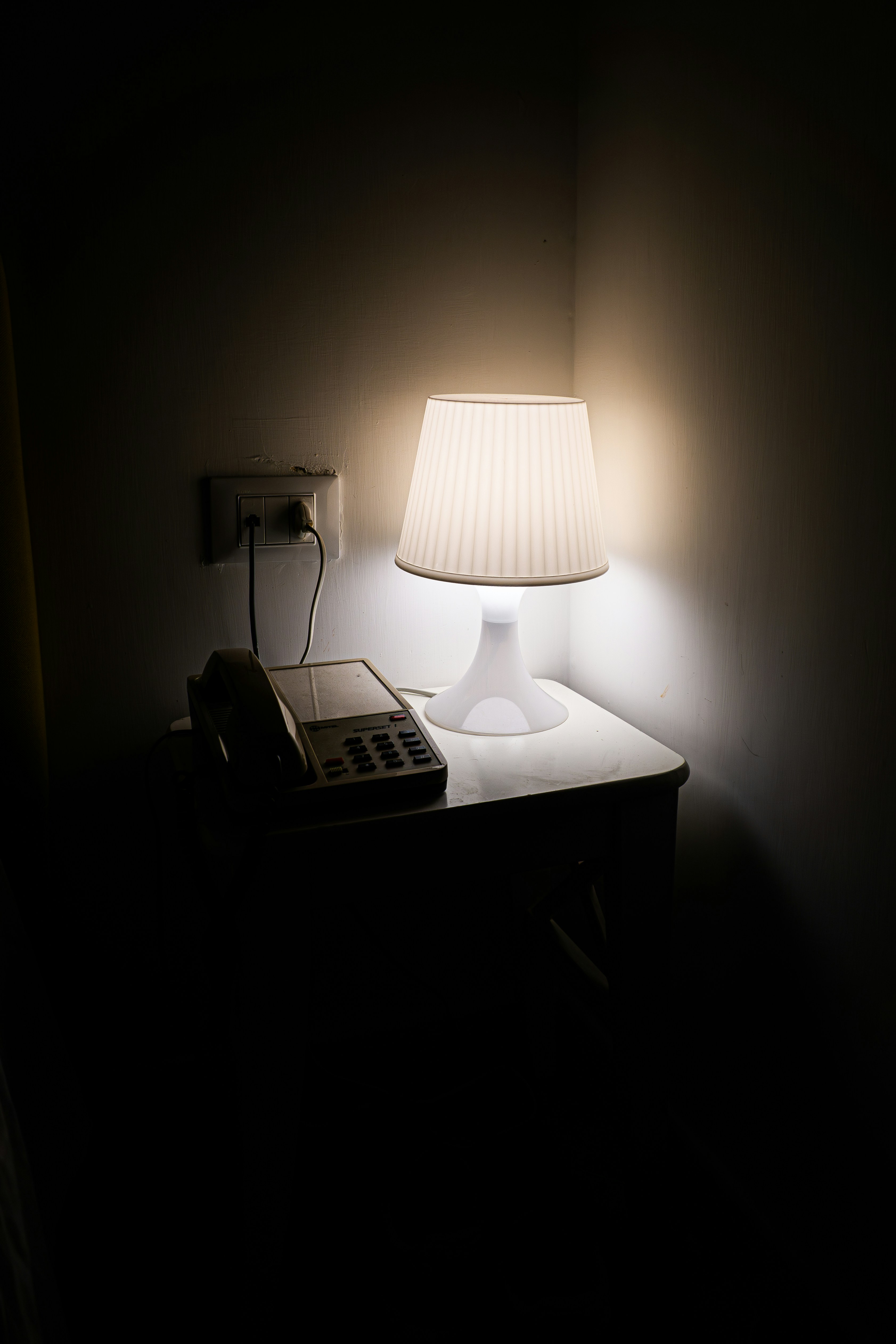 A lamp that is on in a dark room