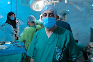 A man wearing a surgical mask standing in a room
