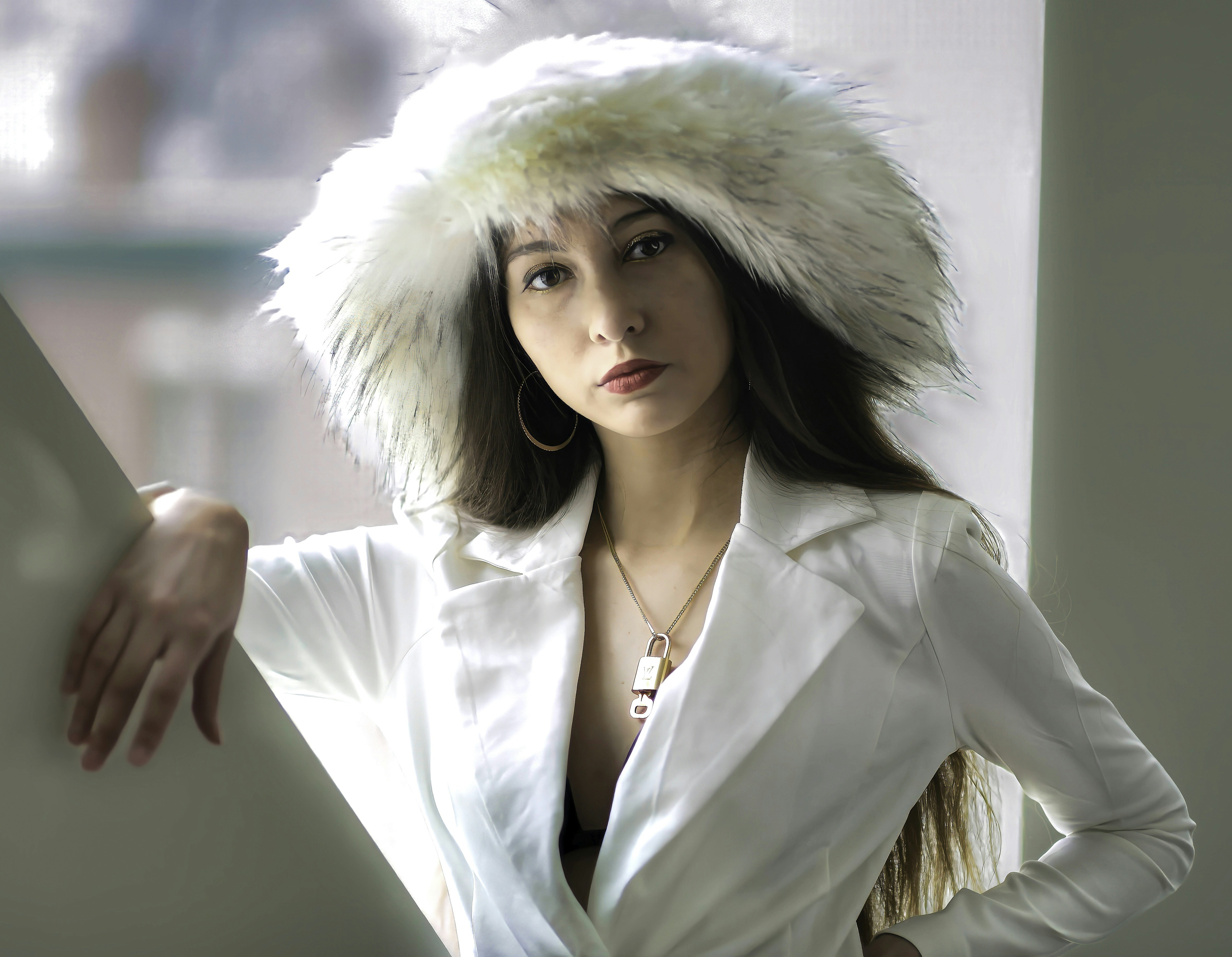 A woman wearing a white jacket and fur hat