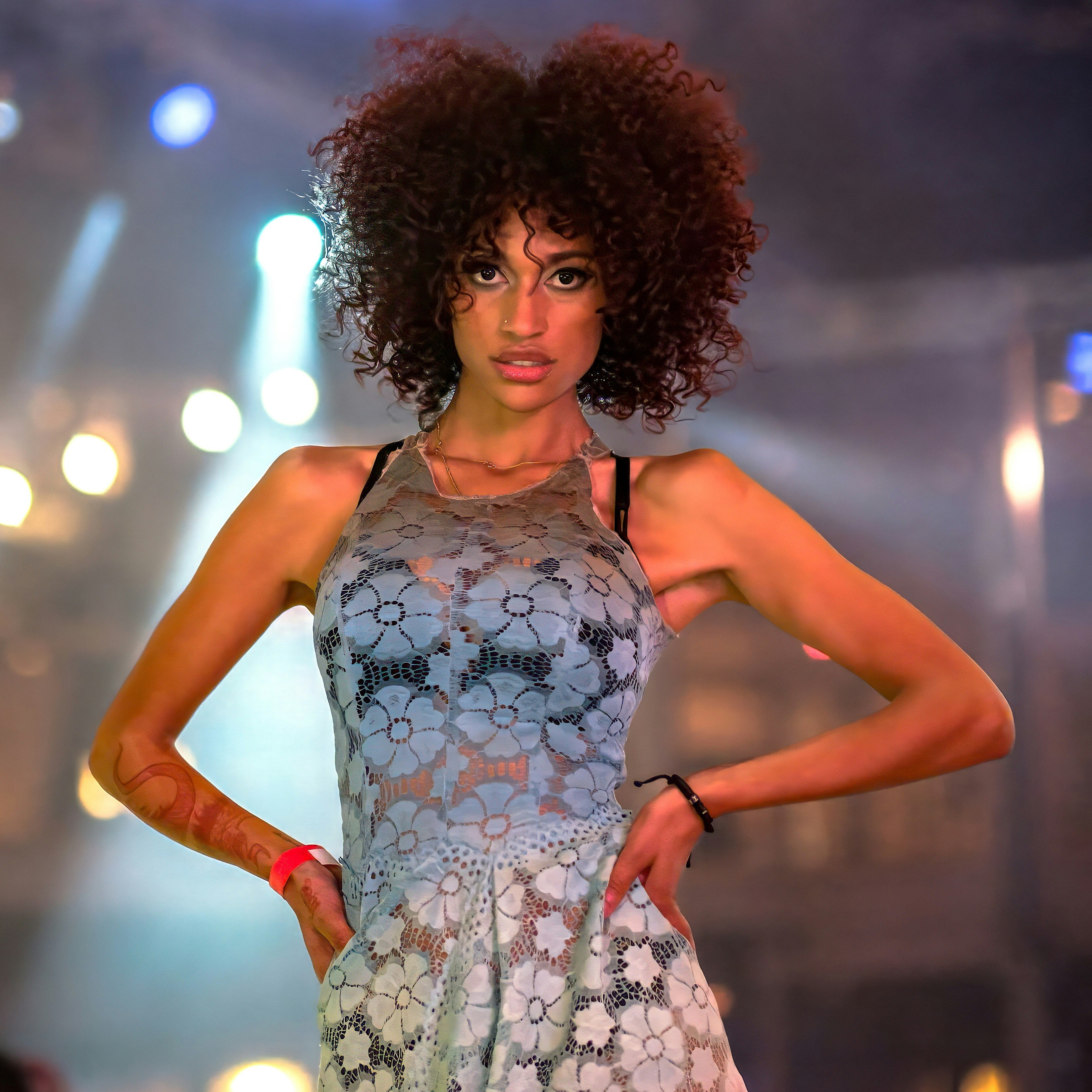 A woman with an afro standing on a runway