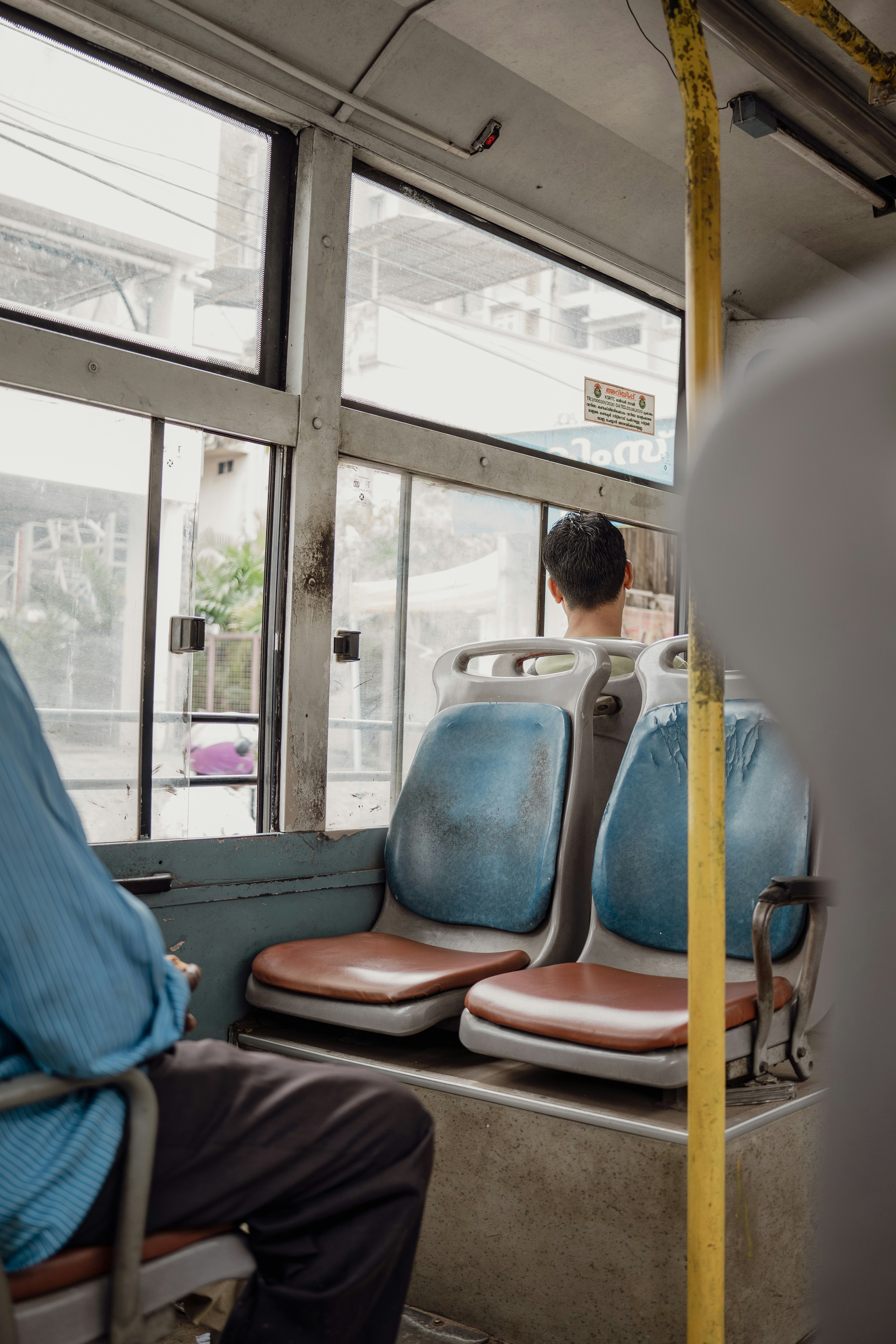 A man sitting on a bus looking out the window