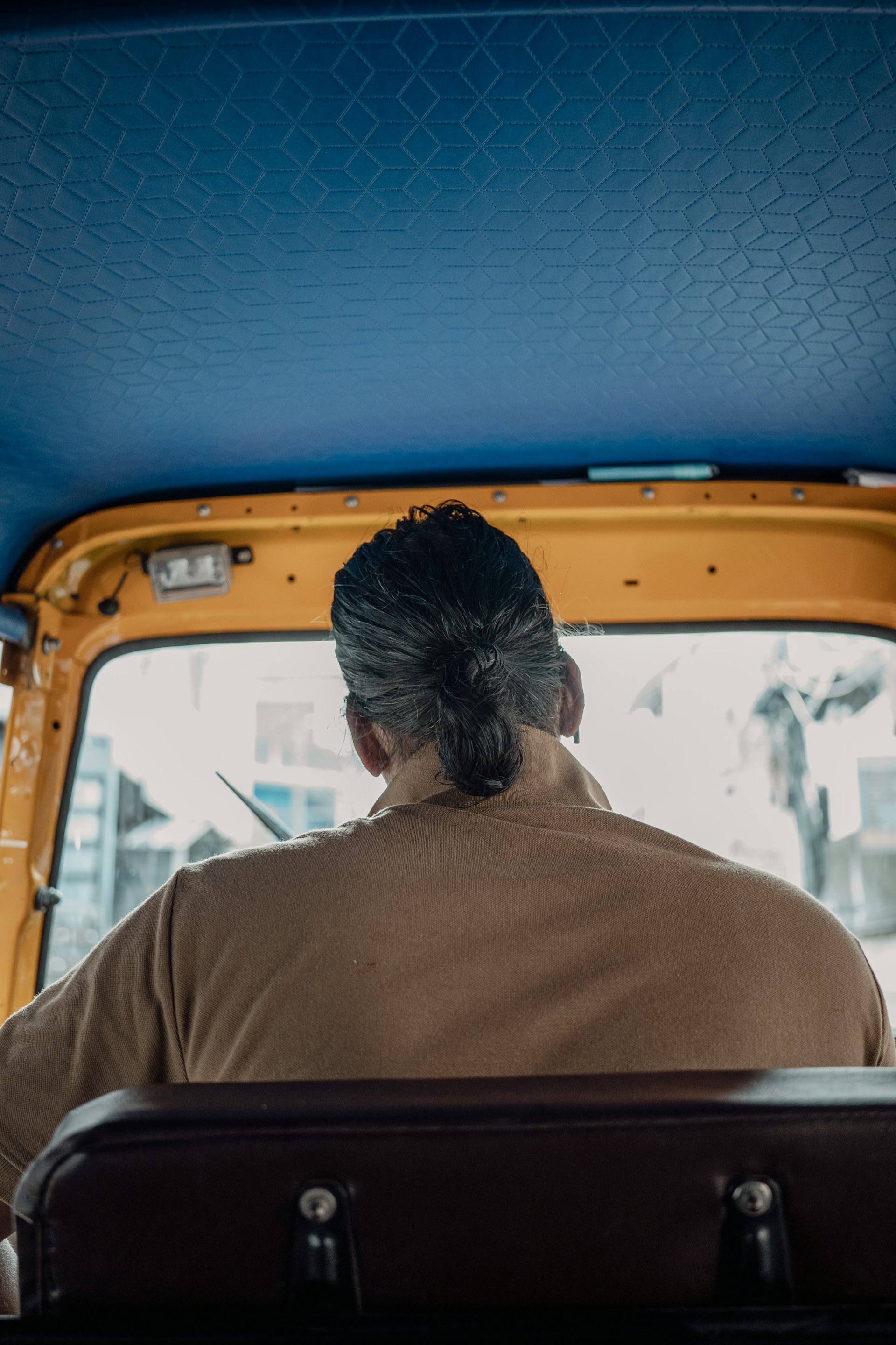 A man sitting in the back of a yellow truck