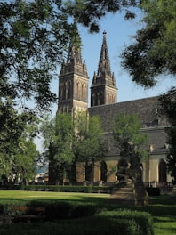 A large church with a tall steeple surrounded by trees