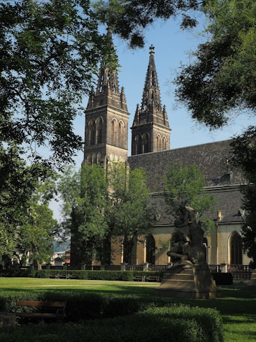 A large church with a tall steeple surrounded by trees