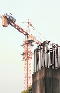 A crane is standing on top of a building