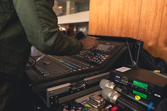 A man standing in front of a bunch of electronic equipment