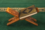 A wooden cross with a book on top of it