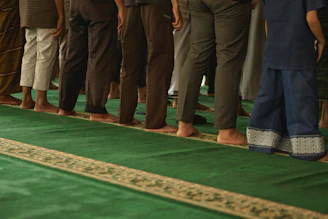 A line of people standing on a green carpet