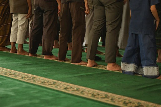 A line of people standing on a green carpet