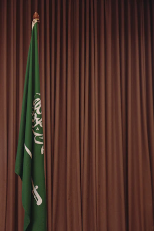 A green and white flag and a brown curtain