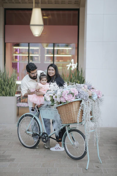 A man and woman with a child on a bicycle