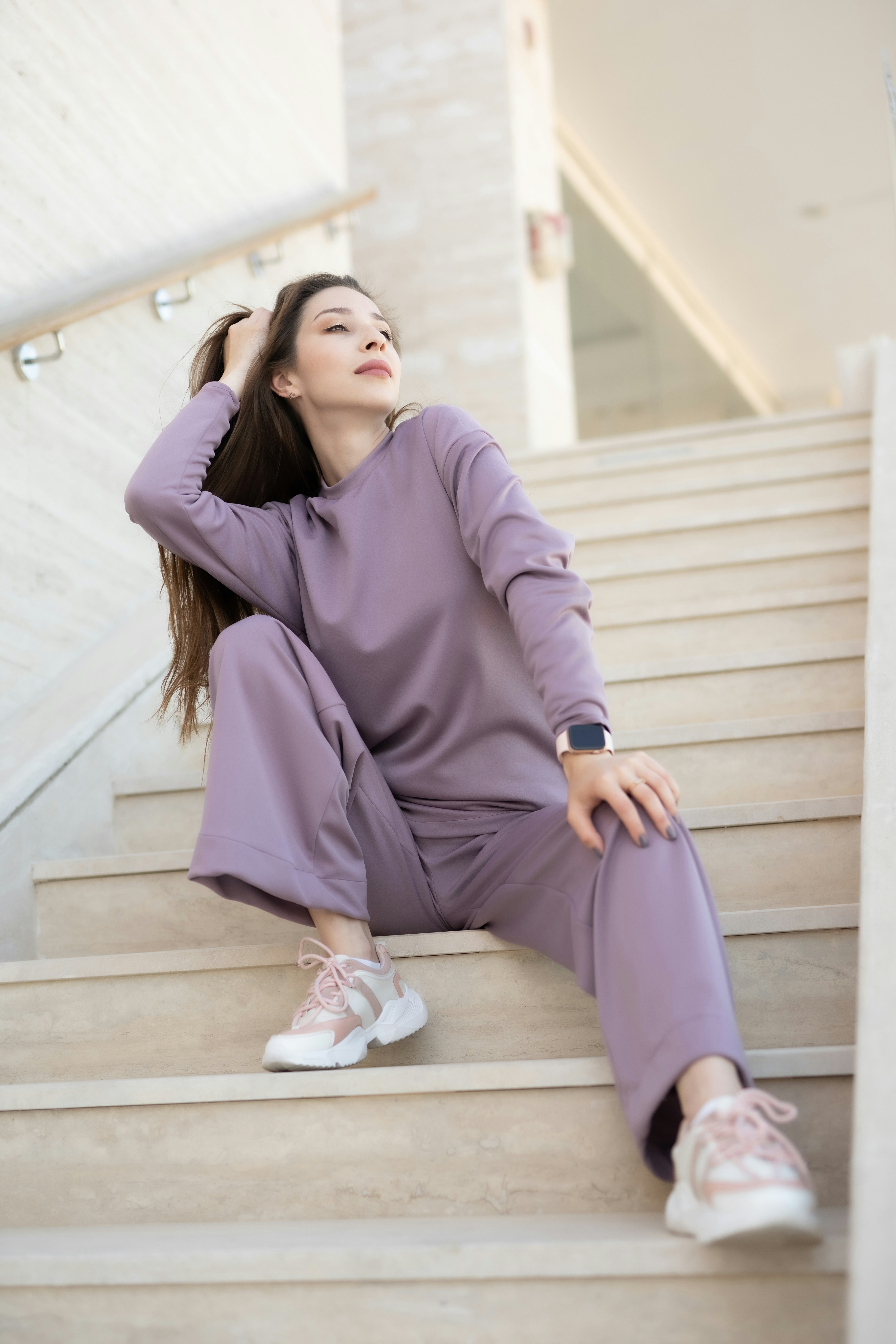 A woman sitting on the steps of a building
