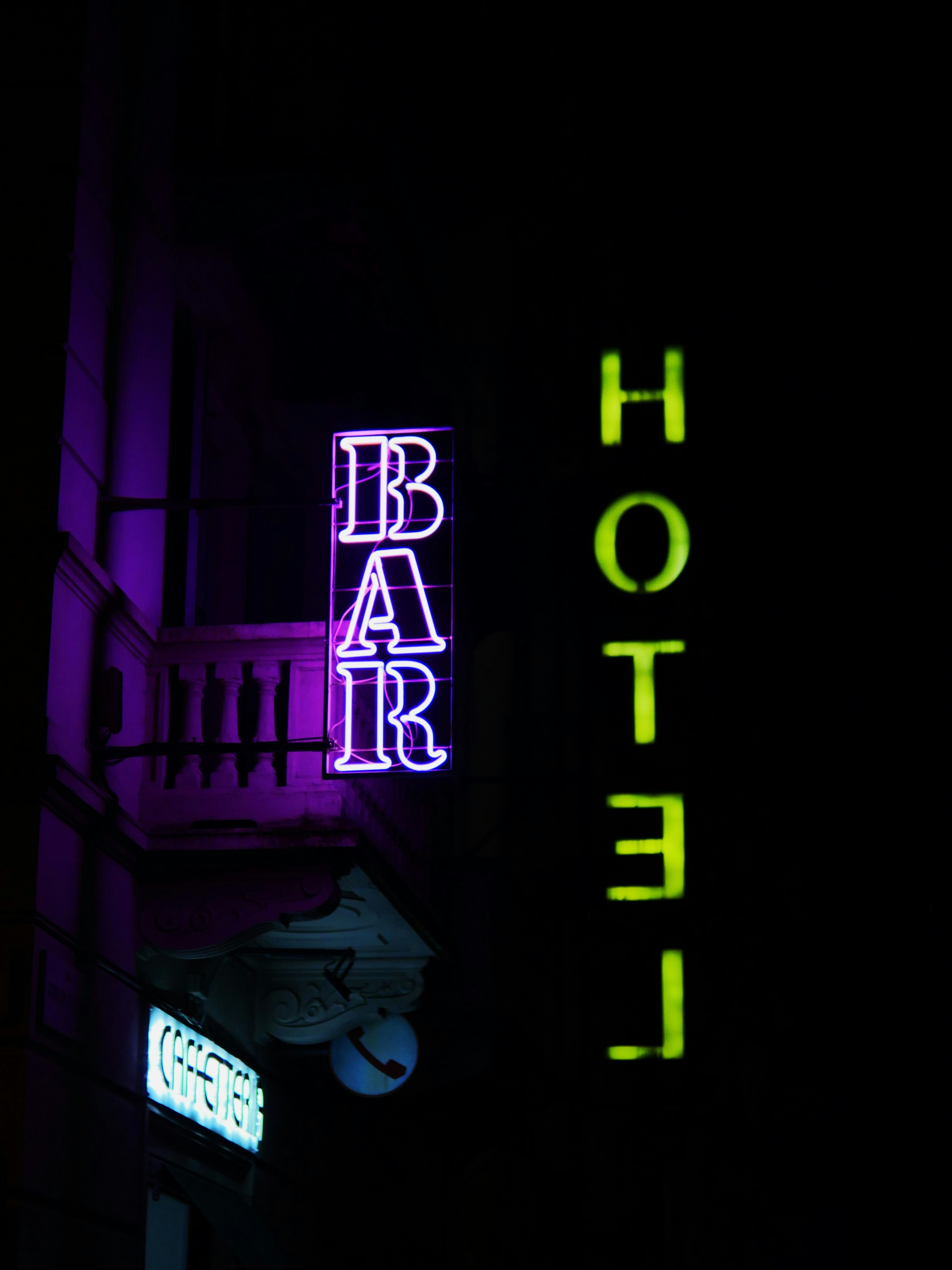 A hotel sign lit up in the dark