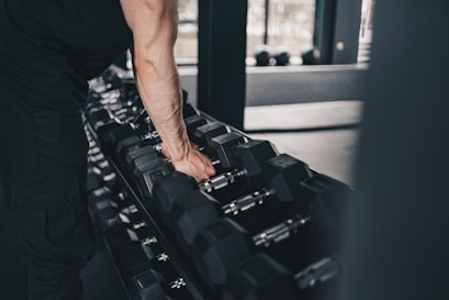 A man holding a gym equipment in a gym