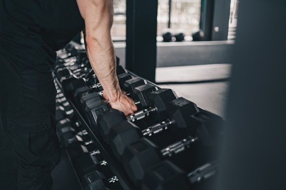 A man holding a gym equipment in a gym