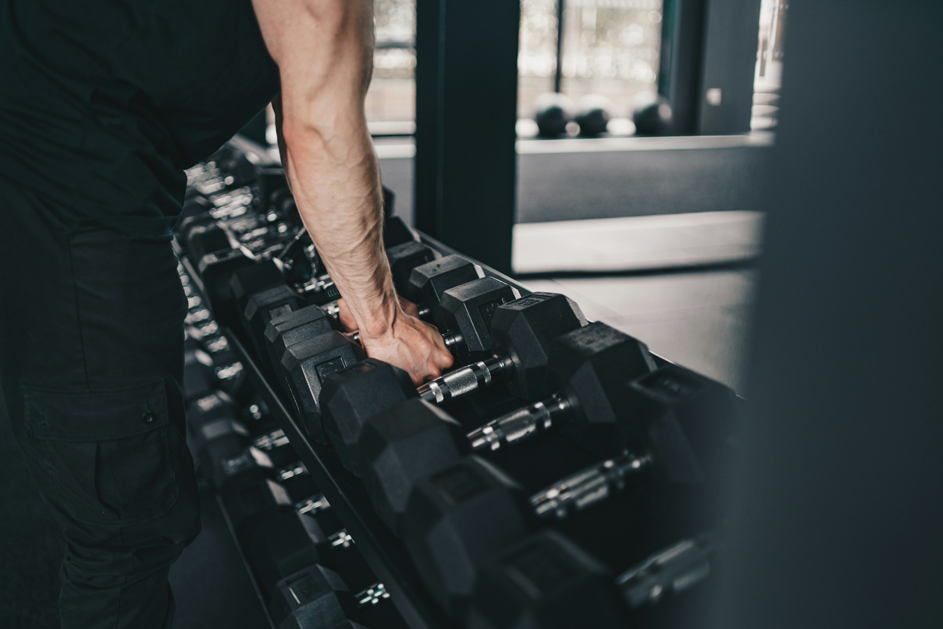 A man holding a gym equipment in a gym