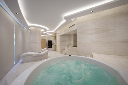 A bathroom with a large jacuzzi tub in the middle of it