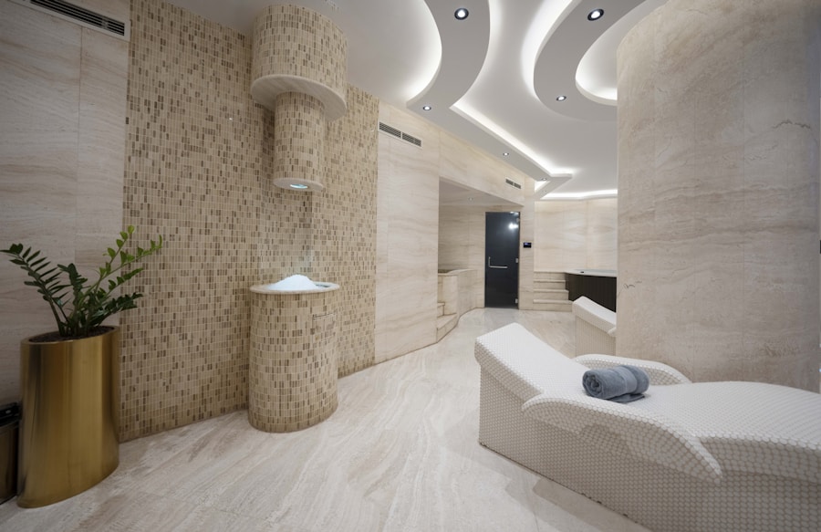 Treatment room in cream stone with a single bed and folded towel