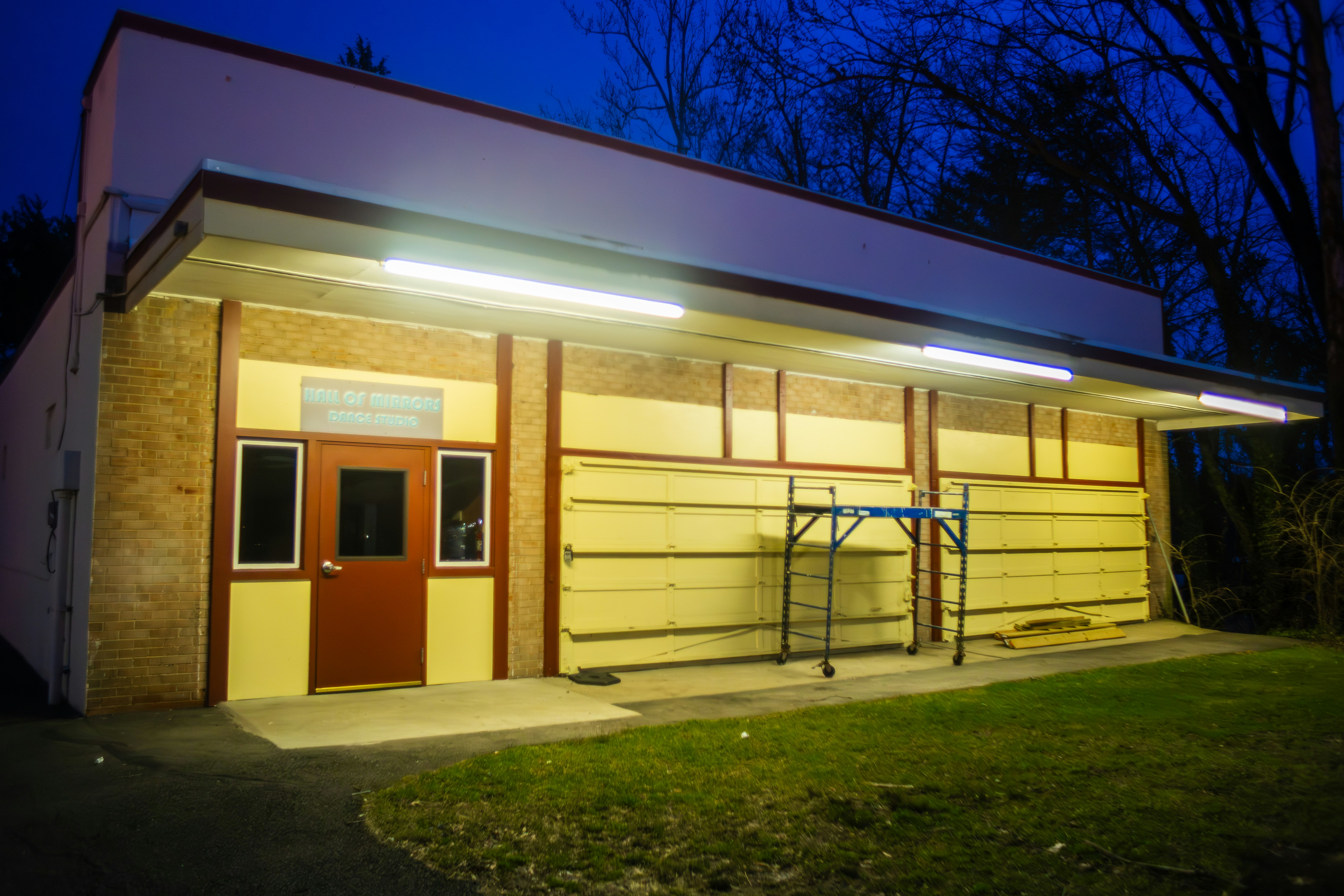 A small building with a red door and a white roof