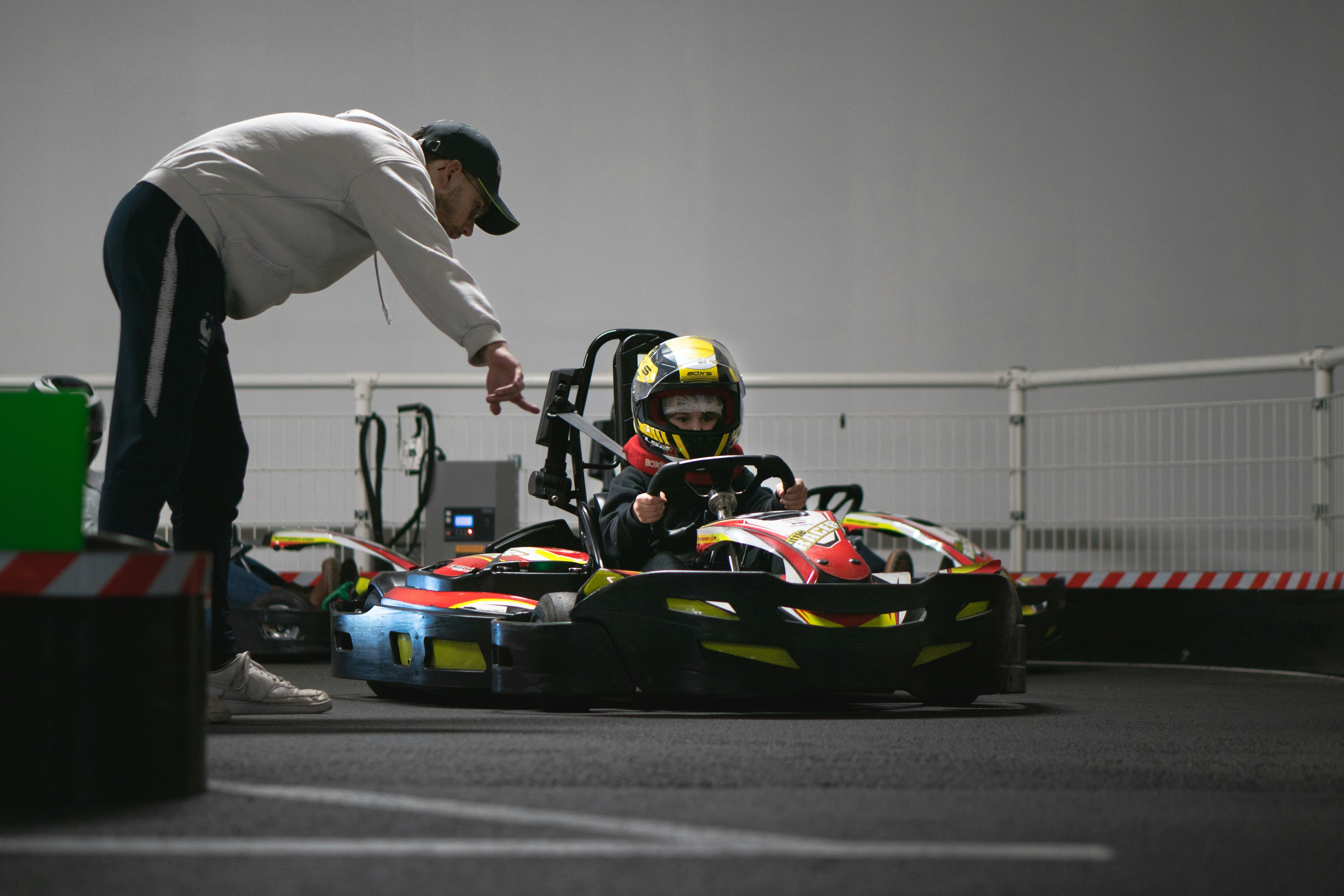 A man standing next to a racing car on a race track