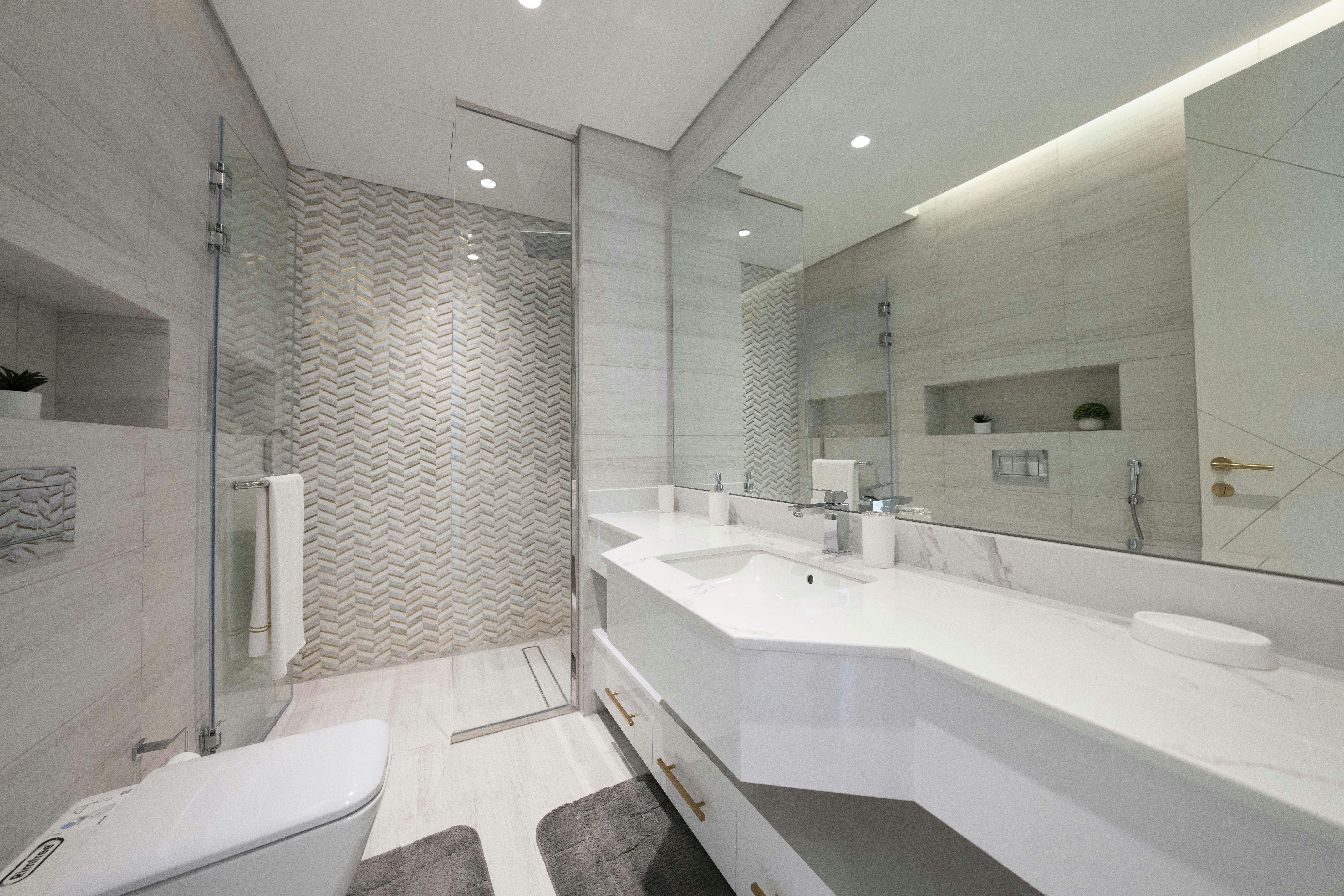 A bathroom with a large mirror and two sinks
