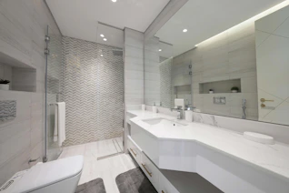 A bathroom with a large mirror and two sinks