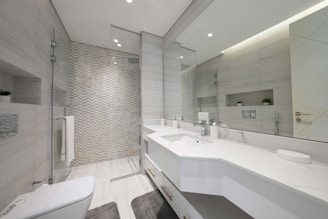 A bathroom with a large mirror and two sinks