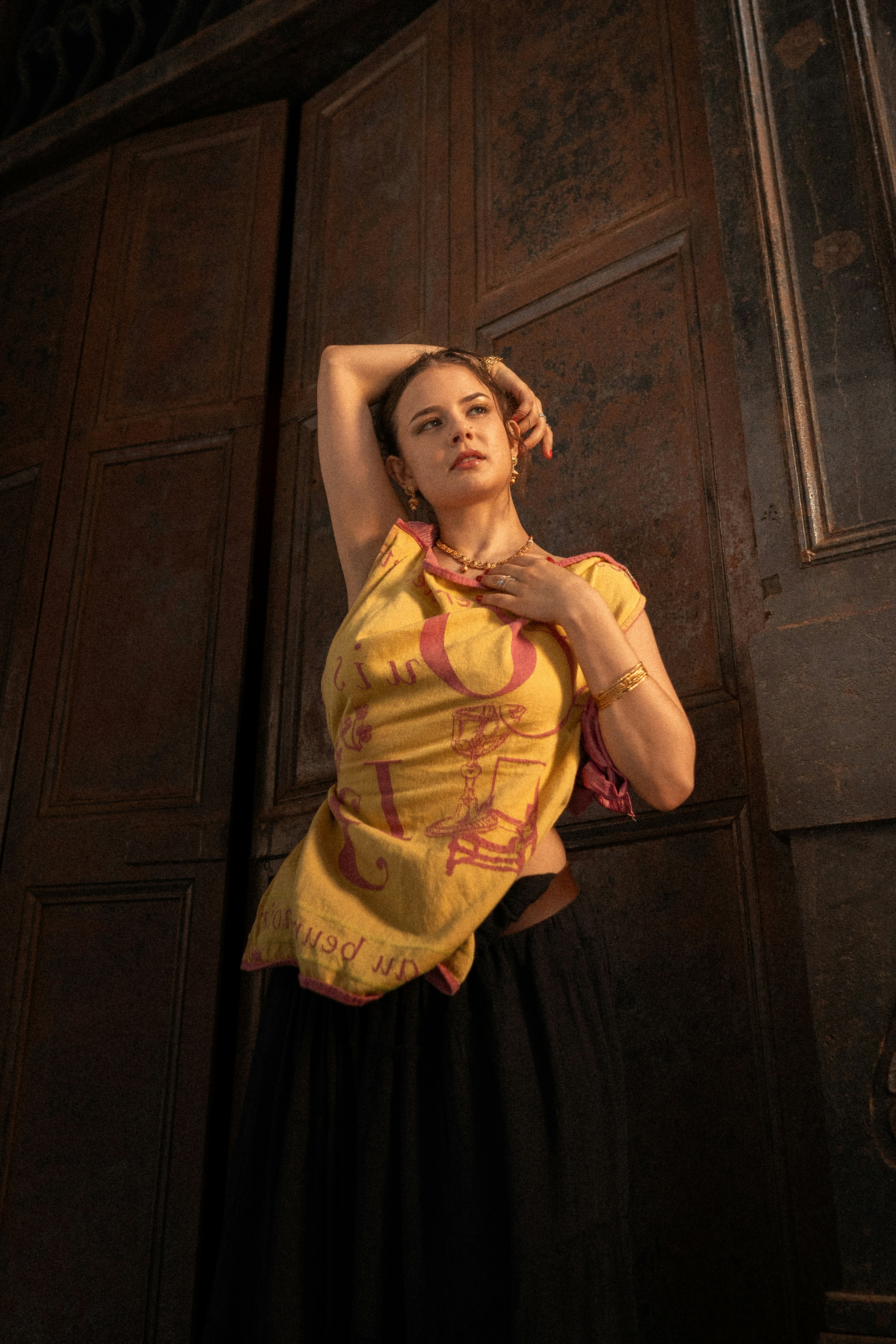 A woman standing in front of a wooden door