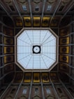 The ceiling of a building with a circular window