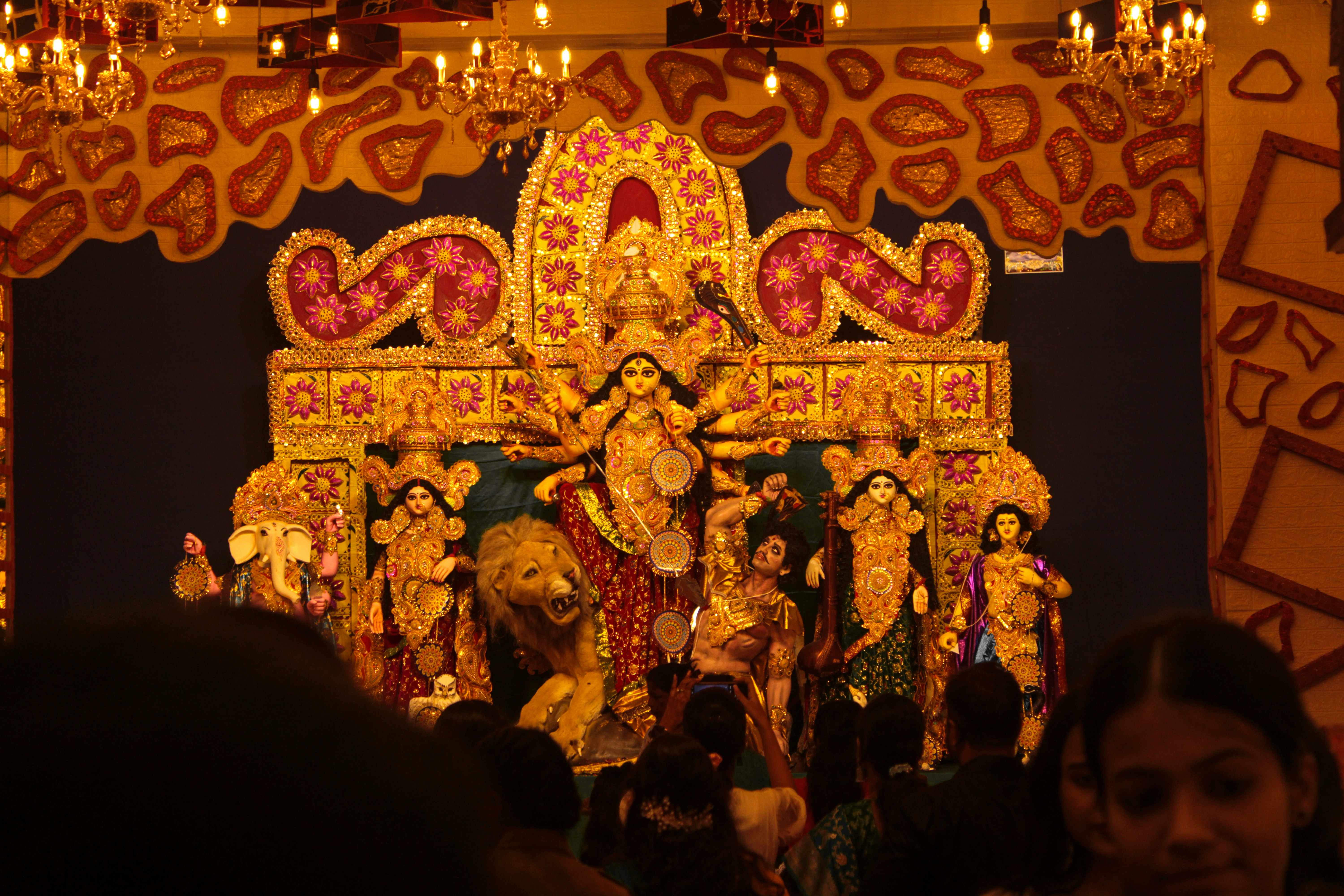 A group of people standing in front of a statue