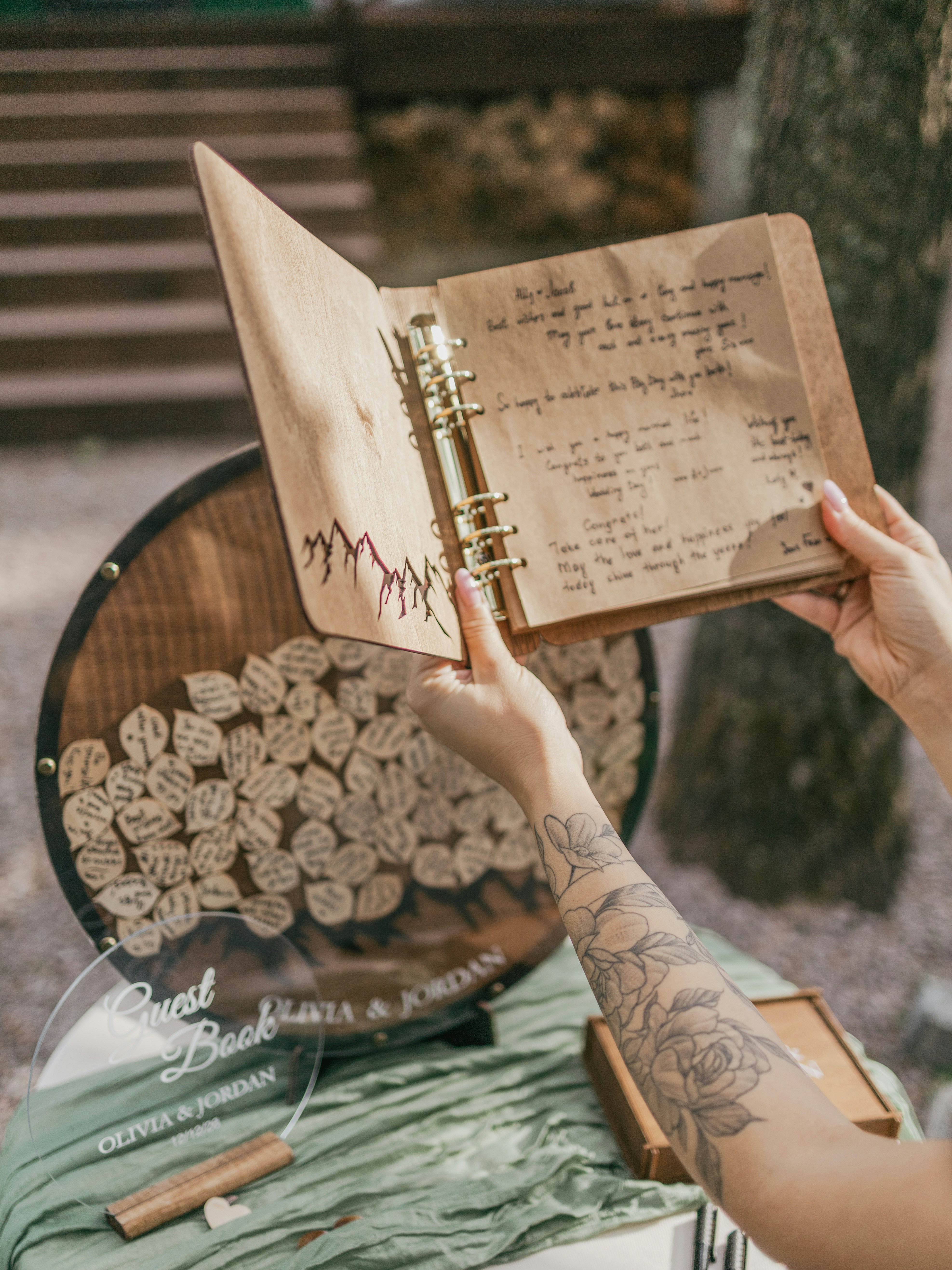 A person holding a notebook with writing on it