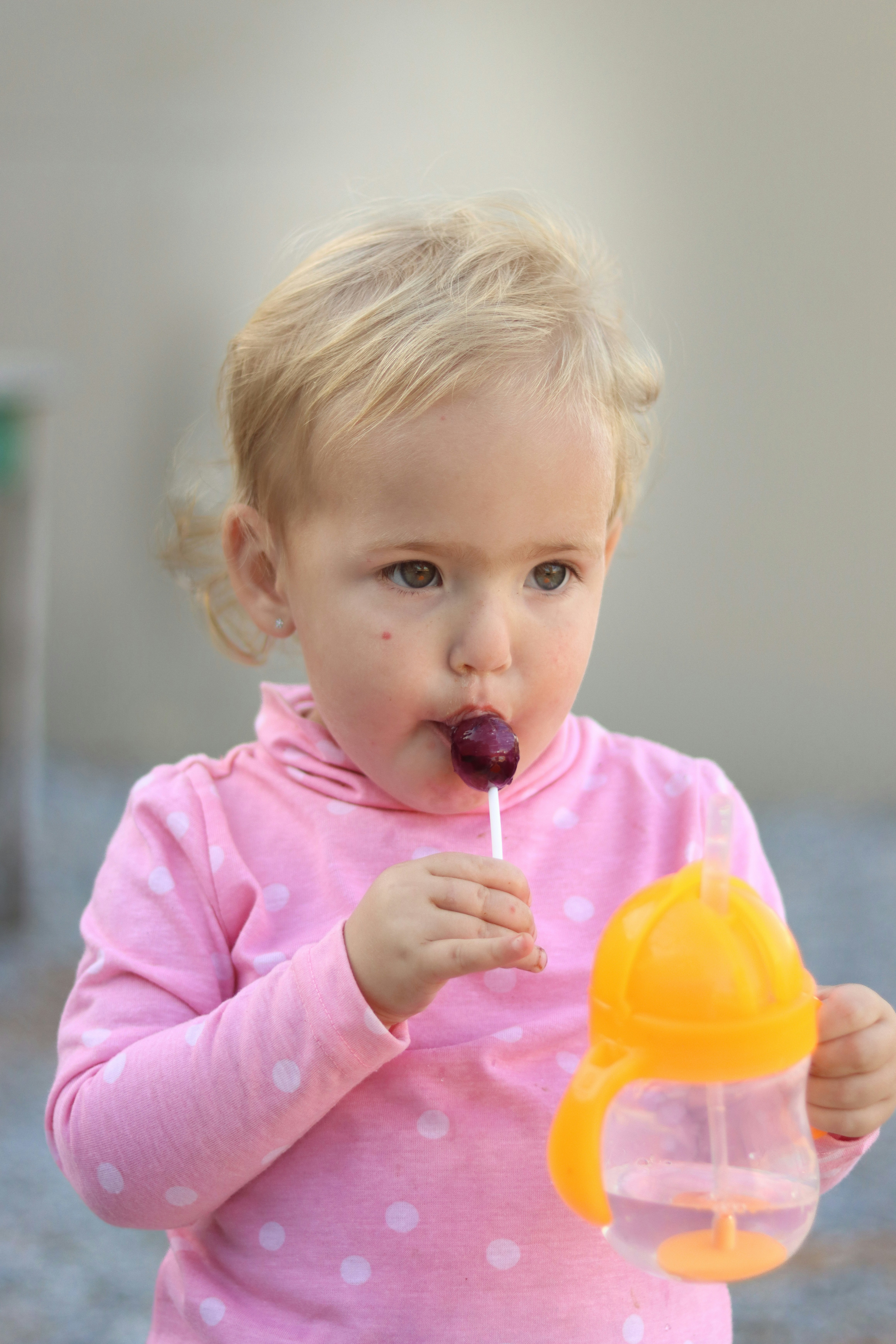 분홍색 셔츠를 입은 어린 소녀가 막대 사탕을 먹고 있습니다. 사진 – Unsplash의 무료 아기 이미지, image size:3000x4500