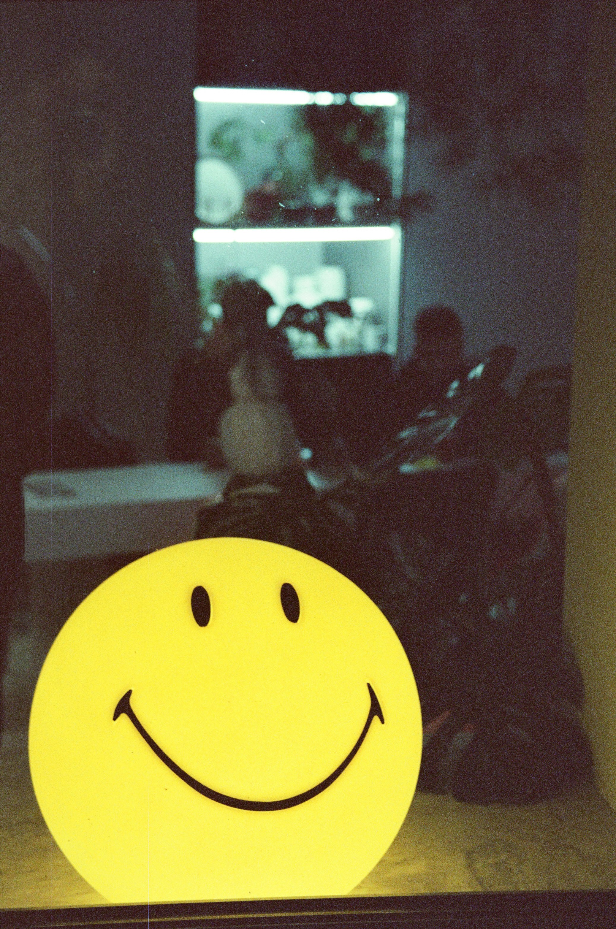 A yellow smiley face sitting on top of a table